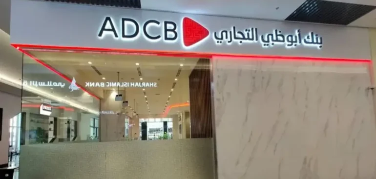 Technicians installing illuminated business signage on a commercial building in Dubai